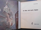 Ein Maler sieht durch's Objektiv.